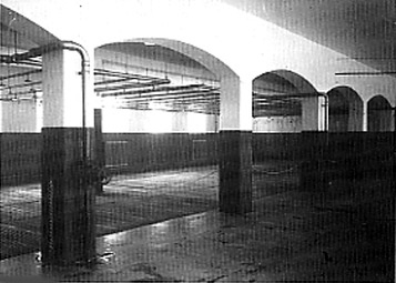 This old photo shows the shower room at Dachau which has been turned into a Museum room